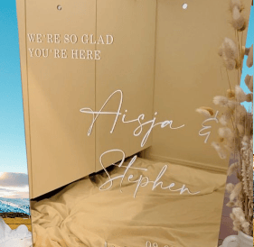 Elegant gold acrylic wedding sign with names Aisja & Stephen.