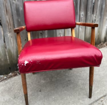 red vinyl vintage chair with edge damage