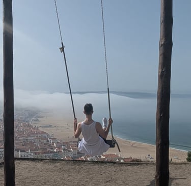 a man sitting on a swing set in a swing