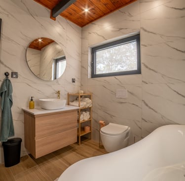 a bathroom with a tub tub and a wooden ceiling