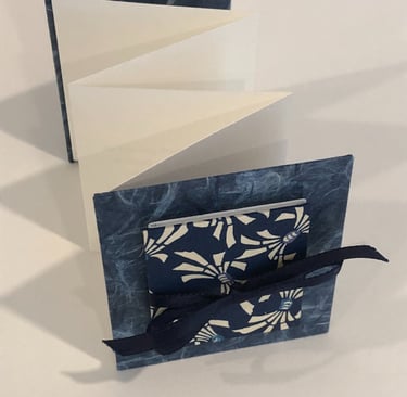 Accordion with Japanese paper and small accordion on cover, ribbon detail