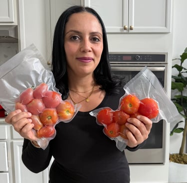By eya holding a bag with whole frozen tomatoes 