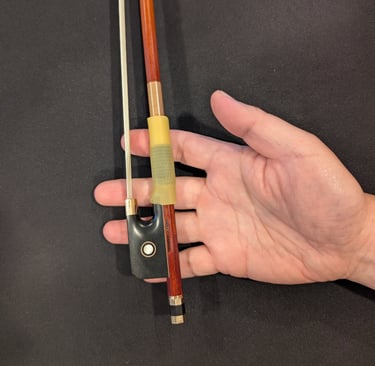 place the bow in the right hand