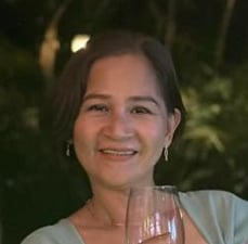 a woman in a green dress holding a wine glass