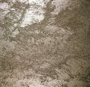 A warm silver paint sample showing its lustre and beautiful grainy texture.