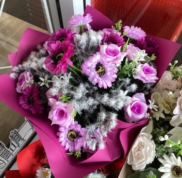 a bouquet of flowers in a vase on a table