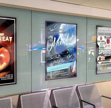 Nightclub event poster displayed at a bus station in large format.