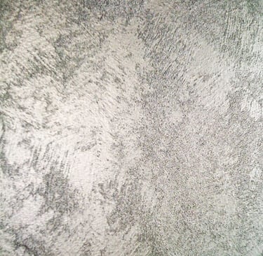 A cool silver paint sample showing off its shimmering grainy texture.