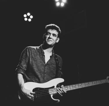 Mosaic's bass player performing a soulful blues-rock groove on stage