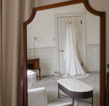 wedding dress hanging from a door frame at highley manor