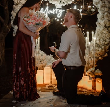 a man and woman standing in front of a wedding arch