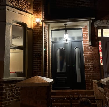 A front door and window illuminated by bright outdoor lights