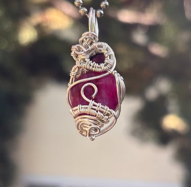 a necklace with a red and white pendant with a dragon on it