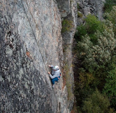 A person climbing a rock face. Photo credit: Brynn Weigelt.