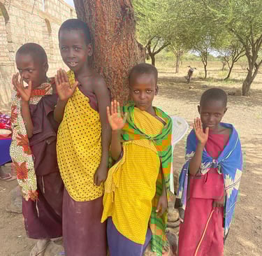 a group of children standing around a tree