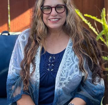 a woman in glasses and a blue shirt
