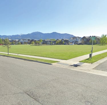 a street scene with a street sign and a car parked on the side of the