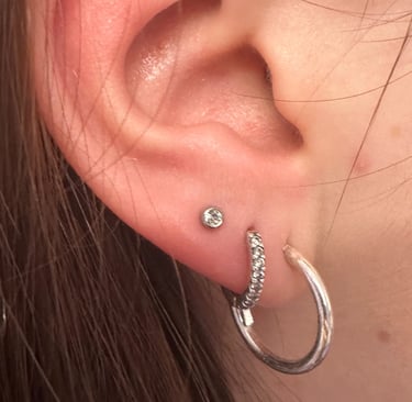 Professional lobe piercing with titanium stud in Montrose