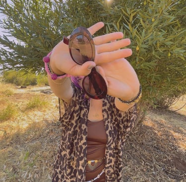 a woman in a leopard print jacket and sunglasses