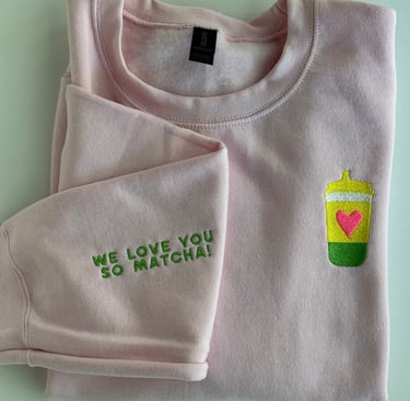 pink sweatshirt with a cup of matcha embroidered on it