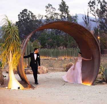 a man in a tuxedo suit and a woman in a pink dress