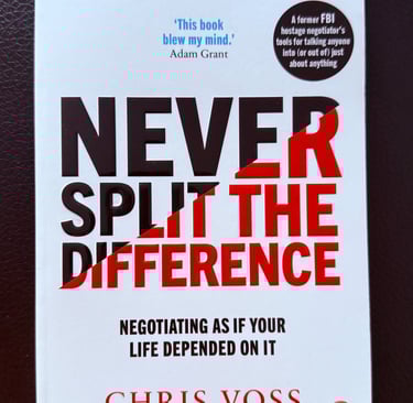 a book cover of Never split the difference