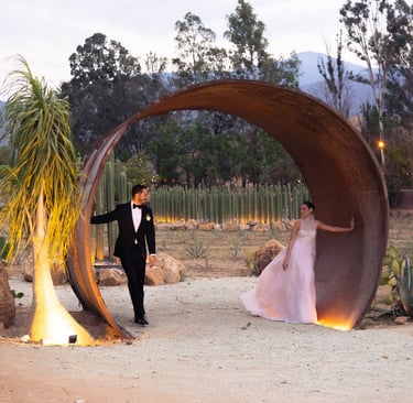 a man in a tuxedo suit and a woman in a pink dress