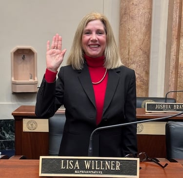 a woman in a suit and red top standing in front of a microphone