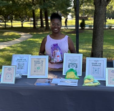 a woman standing behind a table with a table with a table cloth