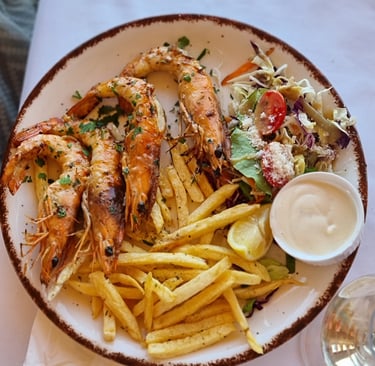 a plate of food with shrimp and fries