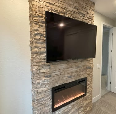TV mounted by At Hand Heroes on custom block fireplace in Peoria AZ with hidden wiring and clean