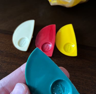 Injection molded disposable sauce containers in various colors, designed by Koorosh Shojaei, 2