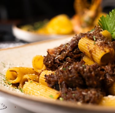 a plate of pasta with pasta and meat
