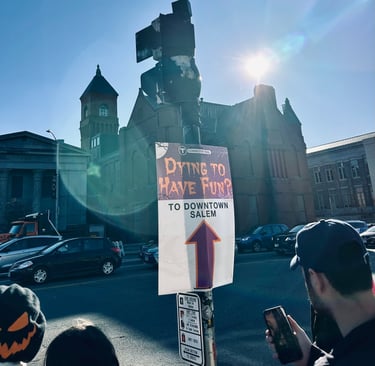 a sign that says "Dying to have fun? To downtown Salem"