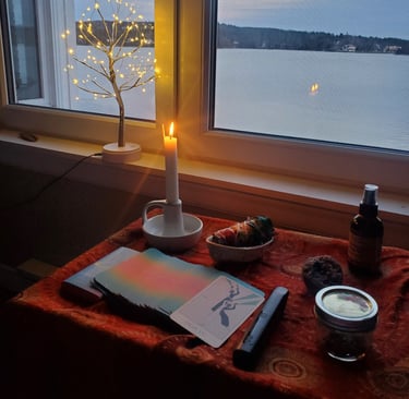 An altar ready for a psychedelic therapy session, with sage, a candle burning and oracle cards