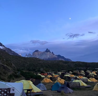A tent pitched up in Paine Grande campsite with Cerro Cuerno Principal