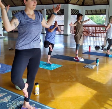a woman in a yoga pose with a yoga mat