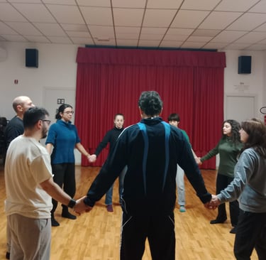 a group of people holding hands in a circle, classe di esercizi di bioenergetica