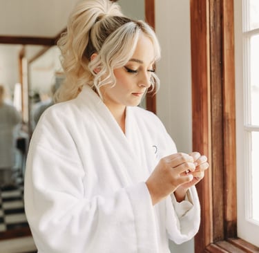 a woman in a white robe is holding a cell phone