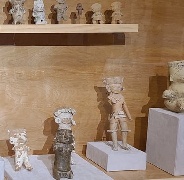 Miniture scultpures depicting Hausteca in display case