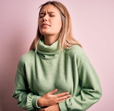 a woman with her hands on her chest and chest, holding her stomach
