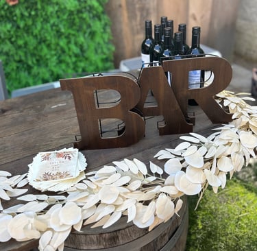 wine bottles with a wooden bar sign