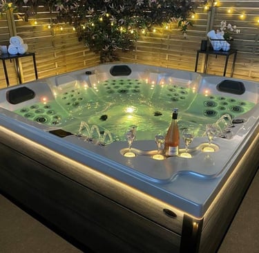 a hot tub with candles and candles on a patio