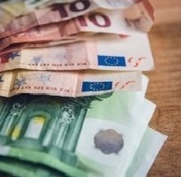 euro banknote collection on wooden surface