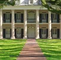 oak alley - a large house with a long driveway and a walkway