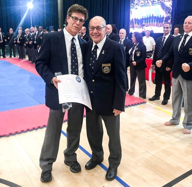 Shihan Michael Monaco receives 8th Dan from Hanshi Steve Arneil at 2019 BKK Open