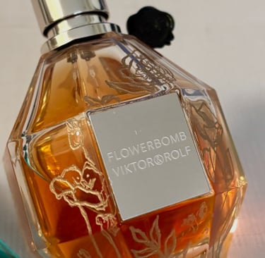 bottle of Flowerbomb perfume with hand engraved flowers that are filled with gold