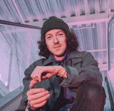 Photographic image of In VideColour's Sam Auckland, sitting in an industrial environment.