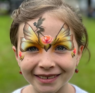 Young girl with face painting of butterfly wings, a fairy and roses. Fairy princess painting