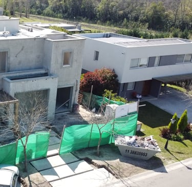 a house with a green tarp and a car parked in front of it